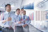 Businessmen discussing graphs and charts seen through screen
